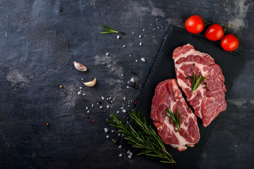 Raw  beef steak on black background, flat lay