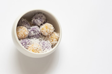 Cropped shot of rice cake stuffed with brown sugar and coated with grated coconut.