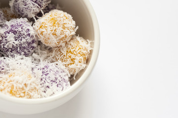 Cropped shot of rice cake stuffed with brown sugar and coated with grated coconut.