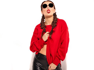 young happy smiling woman model with bright makeup and colorful lips with two horns and sunglasses in summer red clothes isolated on white. Going crazy and showing her tongue