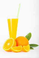 Orange juice and oranges with leaves on white background, vertical