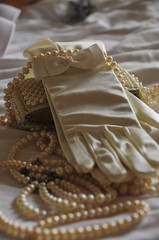 Other foreshortening of the vertical photo. Pearl necklace of a glove and handbag