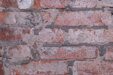 Fragment of an old brick wall of red brick texture background
