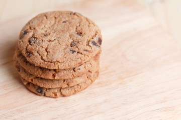 Cookies are stacked on a wooden table