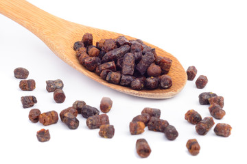 Granules of bee bread in a wooden spoon are isolated on a white background. Apitherapy. Beekeeping products. Strengthening immunity.