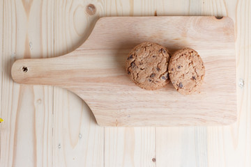 Cookies are stacked on a wooden table