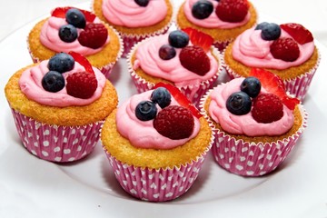 sweet muffin with forest fruits and pink topping
