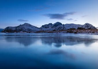 Mountain ridge and reflection in the lake. Natural landscape in the Norway