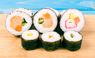 Various kinds of sushi on the blue background.