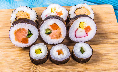 Various kinds of sushi on the blue background.