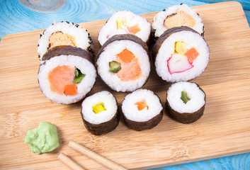 Various kinds of sushi on the blue background.