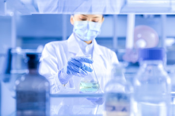 Female scientist looking at the scientific sample in the CDC laboratory	