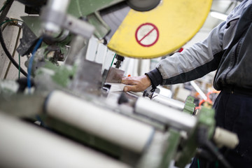 Manual worker assembling PVC doors and windows. Manufacturing jobs. Selective focus. Factory for aluminum and PVC windows and doors production.