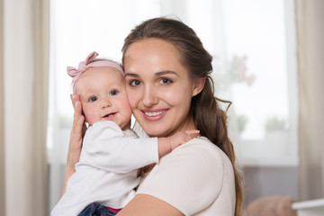 young mother plays with a baby.