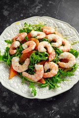 Asian style shrimp salad with wild rocket and blood orange served with lemon wedges and balsamic vinegar drizzle