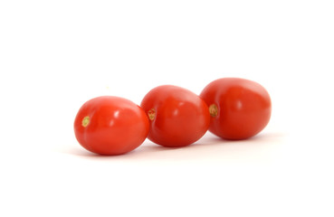 Three red tomatoes on a white background