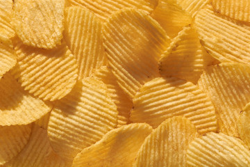 Close up potato chips top view food background.