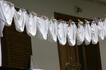 Underpants. The same white underpants hangs outside on a balcony after laundry. Identical underwear...
