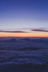 Fototapeta premium sunset with pink and purple tones shot from airplane window seat