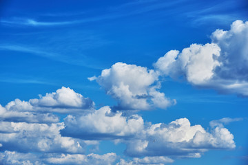 Naklejka na ściany i meble Summer day. Beautiful cumulus clouds in a blue sky. Background