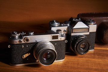 Two film cameras and a camera case made of leather that were made in the middle of the twentieth...