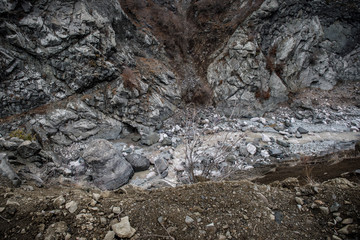 Panorama of the foggy winter landscape in the mountains with snow and rocks, Azerbaijan, Lahic, Big Caucasus