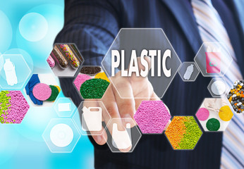 The businessman chooses PLASTIC on the virtual screen in plastic industrial network connection.The...