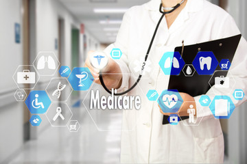 Medical Doctor with stethoscope and Medicare icon in Medical network connection on the virtual screen on hospital background.Technology and medicine concept.