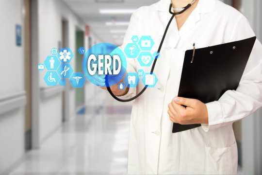 Medical Doctor with stethoscope and word GERD, Gastroesophageal reflux disease in Medical network connection on the virtual screen on hospital background.Technology and medicine concept.