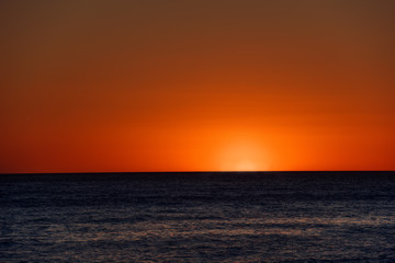 Fototapeta na wymiar Orange sunset above the sea