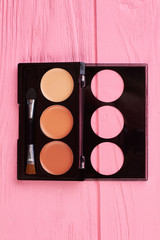 Set of brown eyeshadows, top view. Decorative cosmetics for natural make up. Femininity and elegance concept.