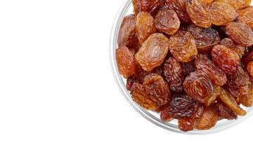 bowl of raisins on a white background. Dried grapes.