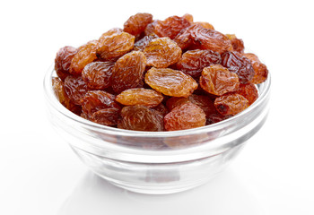 bowl of raisins on a white background. Dried grapes.