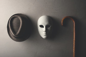 hat white mask and stick hanging on the wall