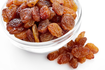 bowl of raisins on a white background. Dried grapes.