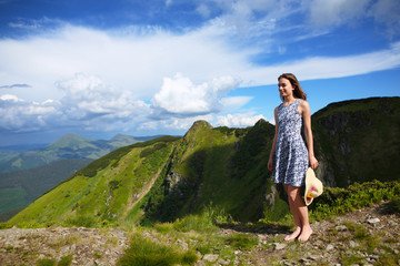 Naklejka premium The girl enjoys landscapes in the mountains of the Carpathians.