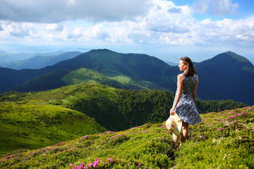 The girl enjoys landscapes in the mountains of the Carpathians.