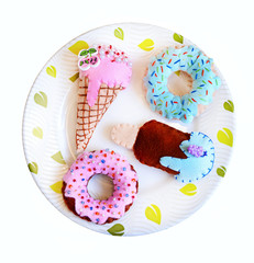 Donuts and ice cream is sewed from felt for a children's game in a shop or cafe