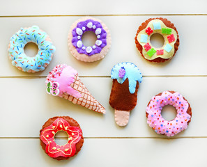 Donuts and ice cream is sewed from felt for a children's game in a shop or cafe