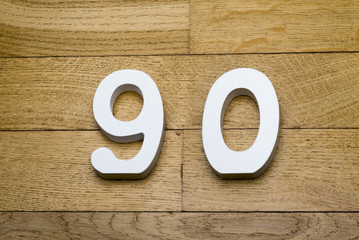 The figures are ninety on the wooden, parquet floor.