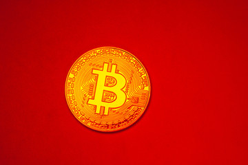 Bitcoin blockchain cryptocurrency coin on a hot red background 