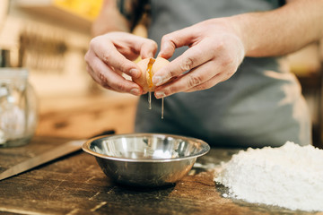 Pasta cooking process, male chef hands with egg