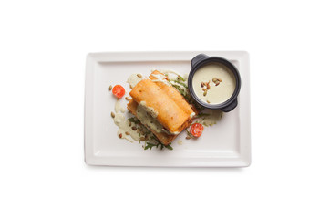 delicious dish in a white plate with soup and vegetables isolated on white