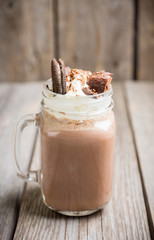 Chocolate milkshake on the rustic background. Selective focus.