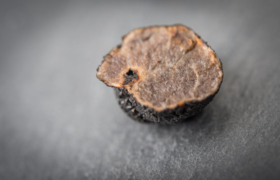 Black truffle mushroom over rustic table