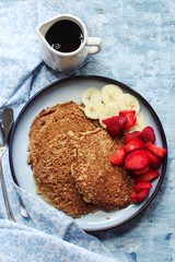 Homemade Oat  wheat Bran Pancakes served with fresh strawberries and banana