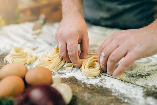 Chef hands preparing pasta, fettuccine preparation