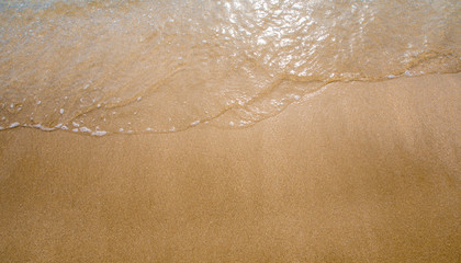 White bubble of Sea wave on the beach