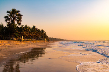 Enjoying the sunset on an idyllic beach in the Gambia, West Africa - obrazy, fototapety, plakaty