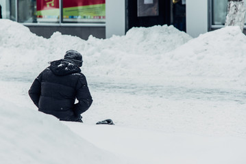 homeless man begs for alms knees in the snow